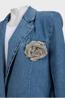 Blue denim jacket with a brooch
