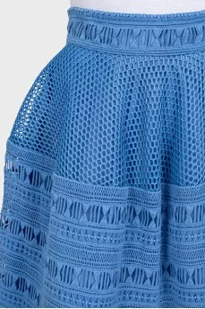 The blue skirt is decorated with drapery