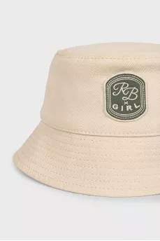 Beige panama hat decorated with a patch