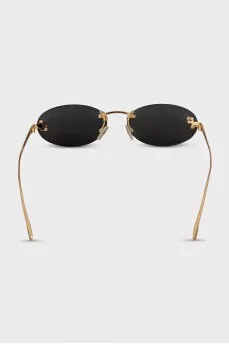 Oval sunglasses with narrow gold temples