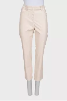 Beige tapered trousers made of eco-leather