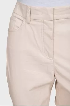 Beige tapered trousers made of eco-leather