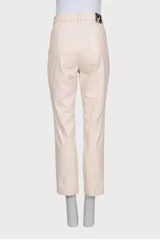 Beige tapered trousers made of eco-leather