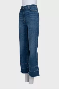 Blue flared jeans with fringe