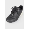 Black and white leather sneakers on lacing
