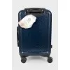Suitcase with reptile embossing
