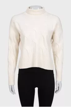 White turtleneck sweater with a textured pattern