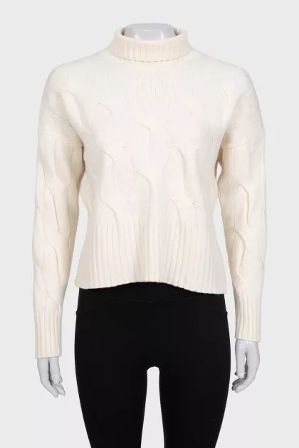 White turtleneck sweater with a textured pattern