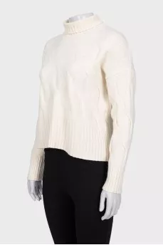 White turtleneck sweater with a textured pattern
