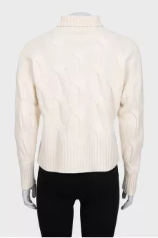 White turtleneck sweater with a textured pattern