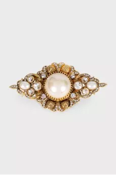 Golden brooch with decor