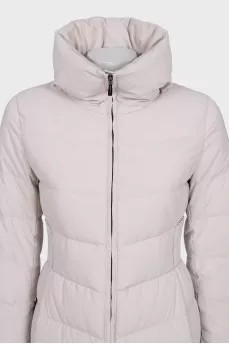 A fitted, elongated down jacket with a zipper