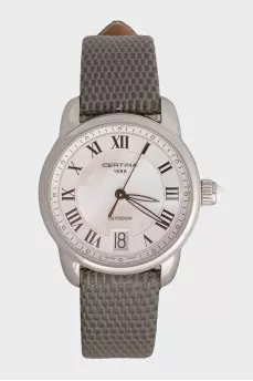 Silver watch with a green leather strap
