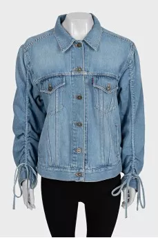 Blue denim jacket with tie sleeves