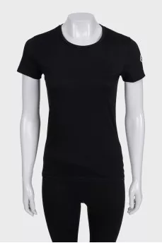 Black T-shirt with a patch on the sleeve