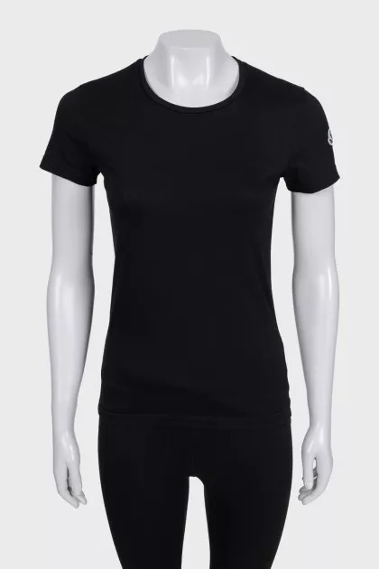 Black T-shirt with a patch on the sleeve