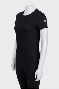 Black T-shirt with a patch on the sleeve