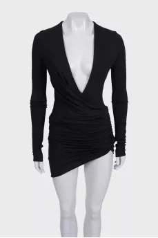 A fitted dress with sleeves decorated with draping
