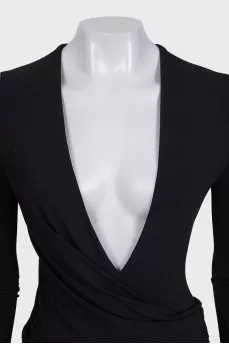 A fitted dress with sleeves decorated with draping