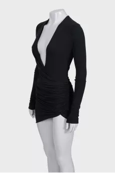 A fitted dress with sleeves decorated with draping