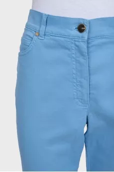 High-waisted blue jeans with a gold button