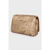 Golden patterned clutch bag