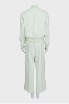 The green tracksuit is decorated with stripes