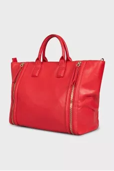 Red leather bag with decorative zippers