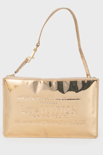 Golden clutch from a brand's logo