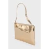 Golden clutch from a brand's logo