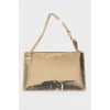 Golden clutch from a brand's logo