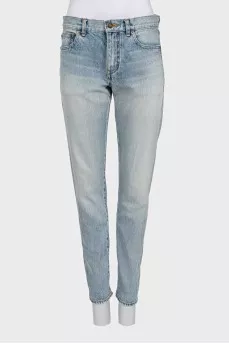 Light blue straight leg jeans with a ripped effect at the bottom