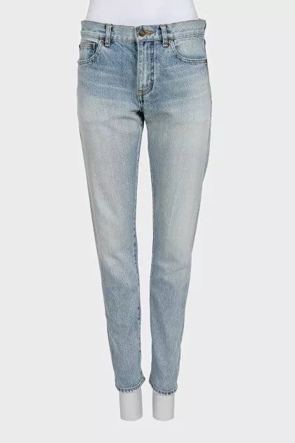 Light blue straight leg jeans with a ripped effect at the bottom