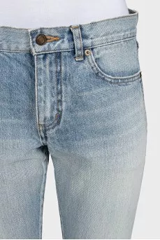Light blue straight leg jeans with a ripped effect at the bottom