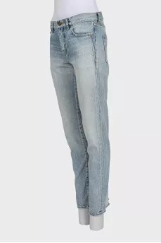 Light blue straight leg jeans with a ripped effect at the bottom