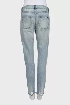Light blue straight leg jeans with a ripped effect at the bottom