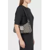 A textile shoulder bag with a signature print