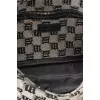 A textile shoulder bag with a signature print