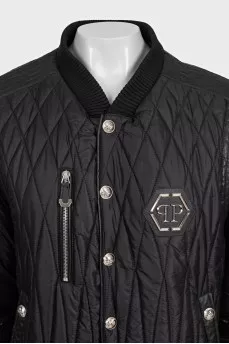 Black quilted bomber jacket with signature logo on the back