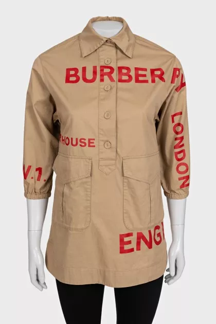 Beige shirt with a contrasting logo