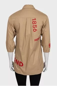 Beige shirt with a contrasting logo
