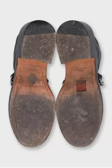 Black leather boots with a silver chain