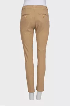 Beige tapered trousers with a mid-rise