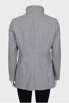 A cropped coat with a fitted cut and a button