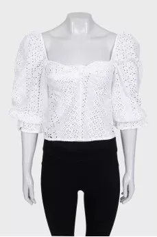 White blouse with puffed sleeves decorated with perforations