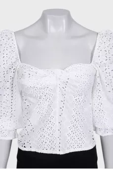 White blouse with puffed sleeves decorated with perforations