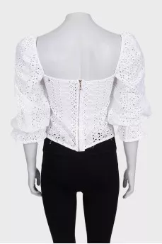 White blouse with puffed sleeves decorated with perforations