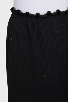 Black fitted skirt decorated with starbursts
