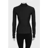 Black turtleneck with a 3D pattern and tag