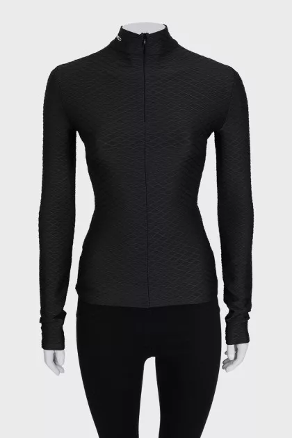 Black turtleneck with a 3D pattern and tag